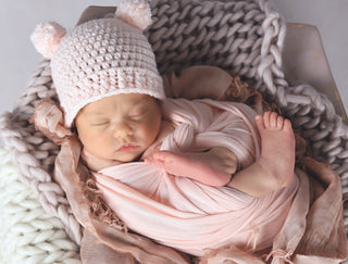 Pale pink mini pom pom hat