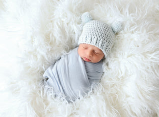 Pale blue mini pom pom hat