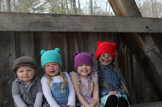 Red, orchid, and aqua blue mini pom pom hat with taupe Irish wool newsboy hat