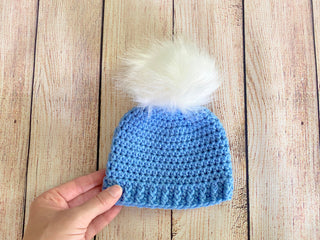 Blue faux fur pom pom hat