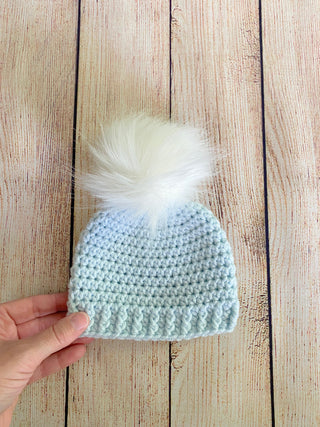 Pale blue faux fur pom pom hat