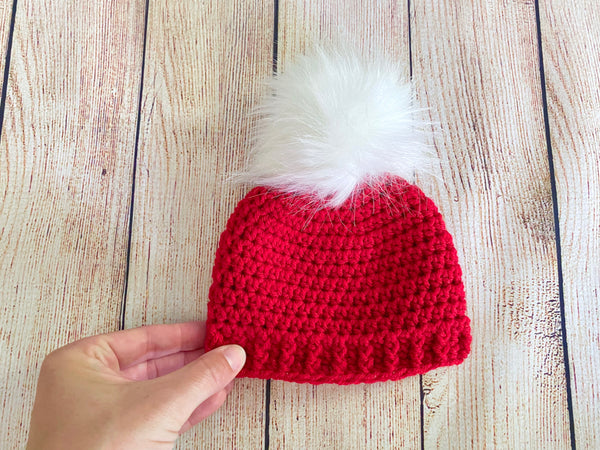 Red faux fur pom pom hat