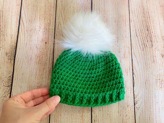 Green faux fur pom pom hat