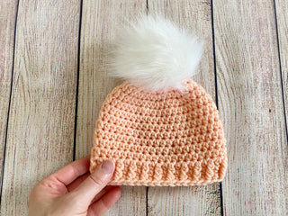 Peach faux fur pom pom hat