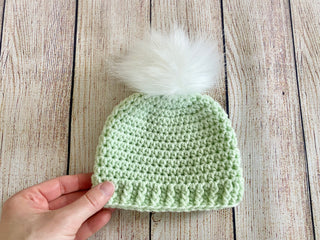 Pale green faux fur pom pom hat