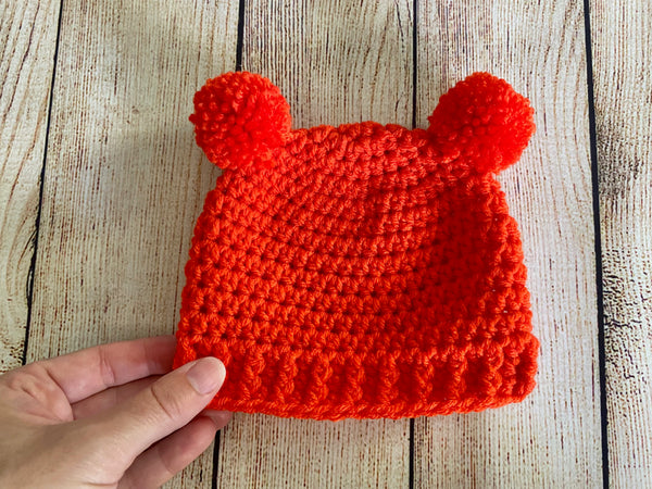 Orange mini pom pom hat