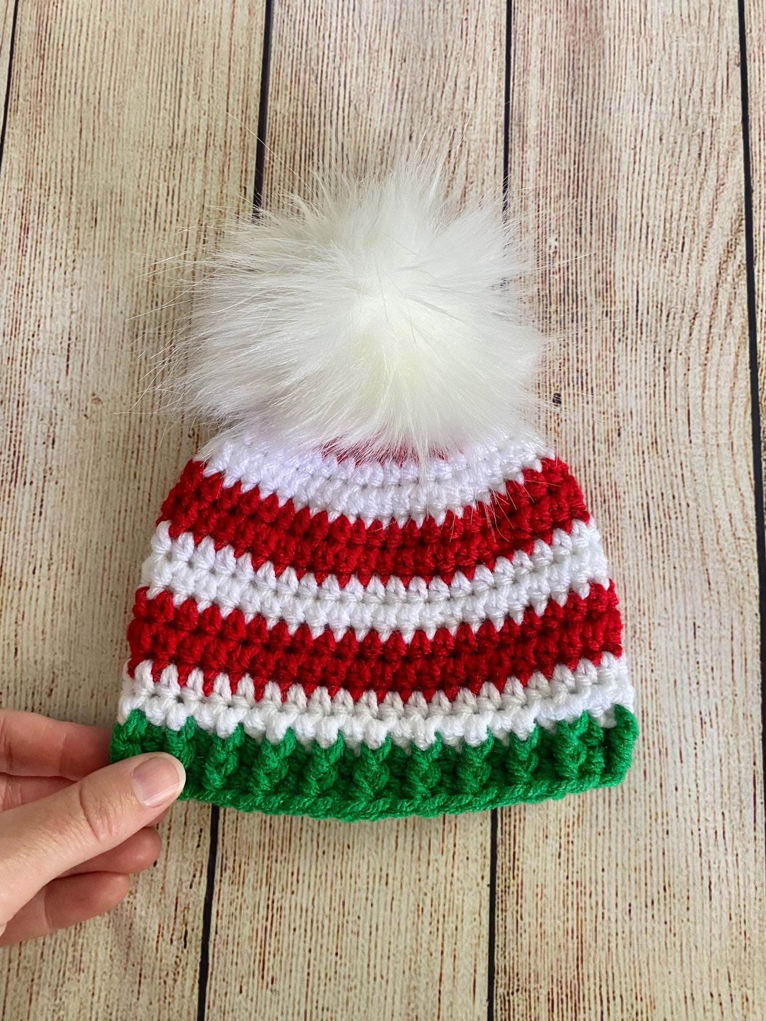 Red, white, and green faux fur pom pom striped Christmas hat by Two Seaside Babes