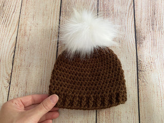 Brown faux fur pom pom hat