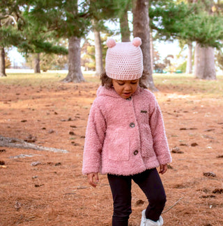 Pale pink mini pom pom hat