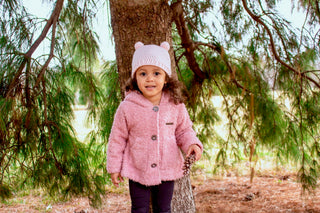 Pale pink mini pom pom hat